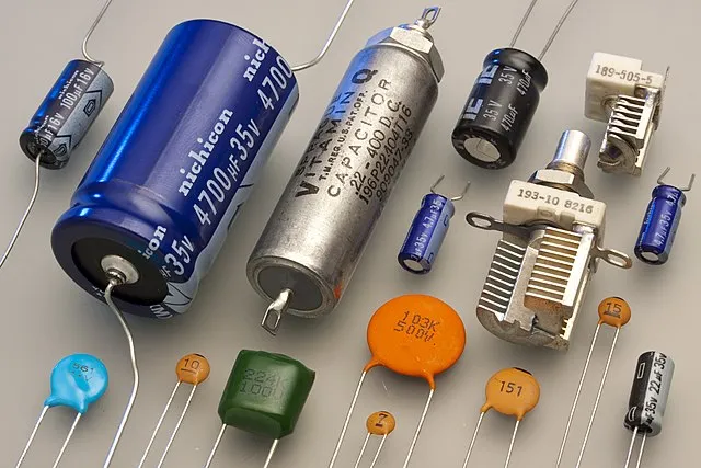 A close-up of various electronic devices showcasing different types of capacitors used in different applications.