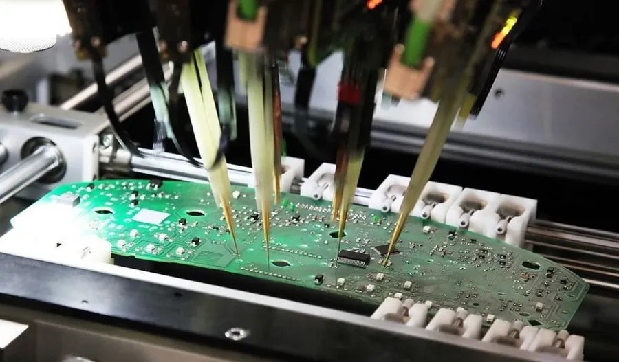 A PCB undergoing testing with specialized equipment.