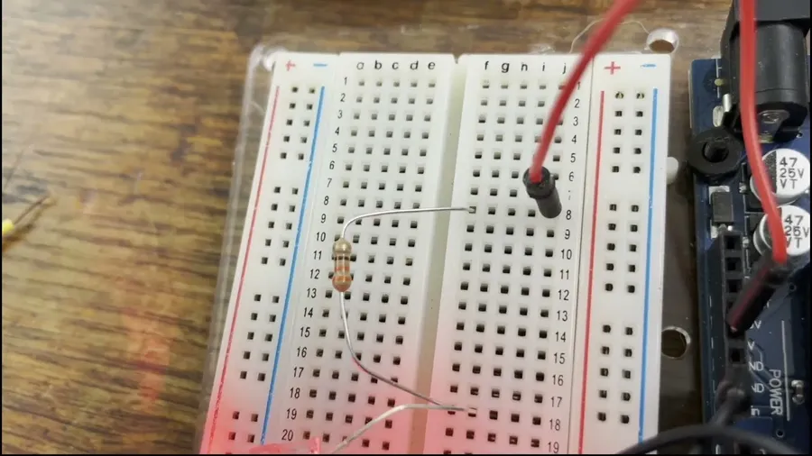 A 10k resistor connected on a breadboard.