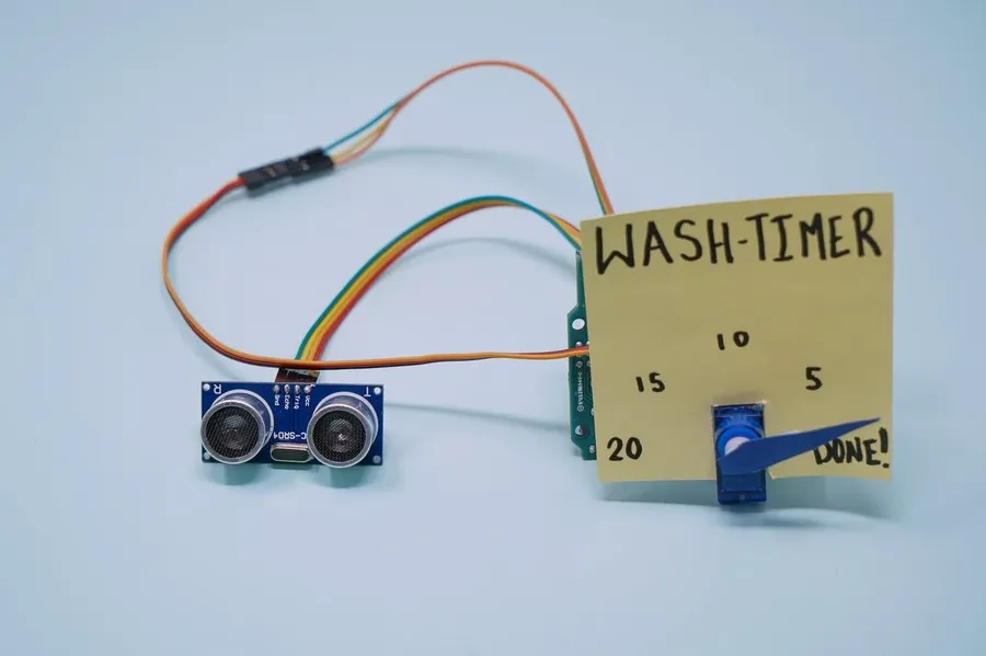 A person working on a DIY electronics project with various components.