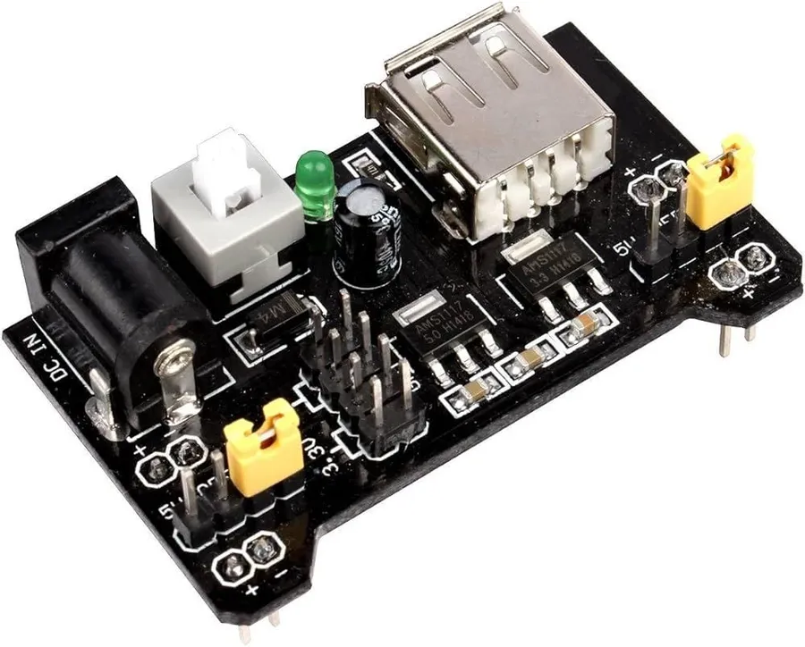 A breadboard with a power supply module connected to it.