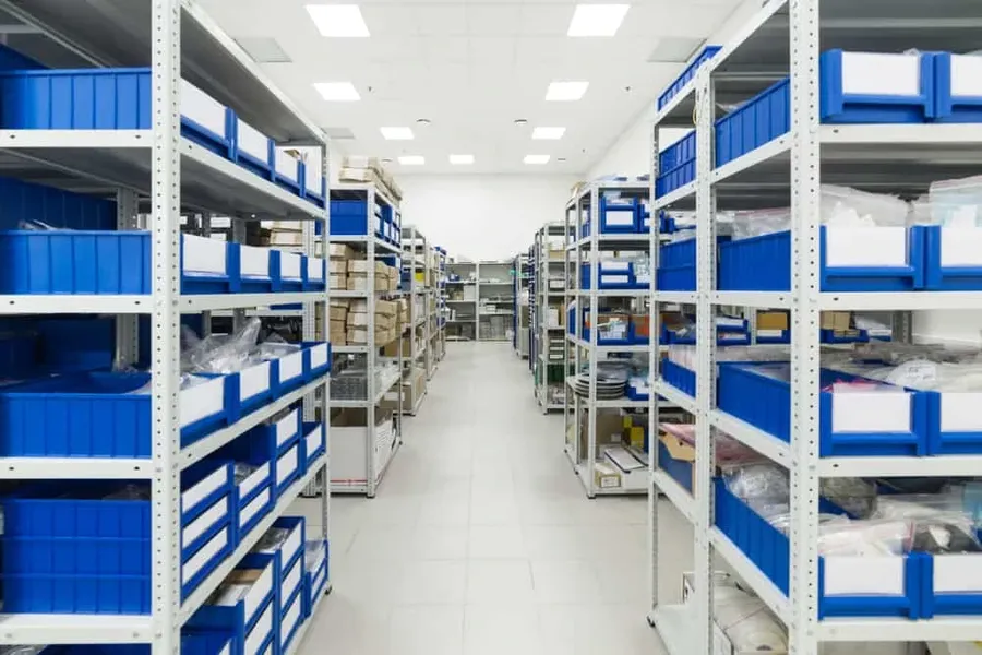 A warehouse aisle filled with shelves of packaged electronic components.