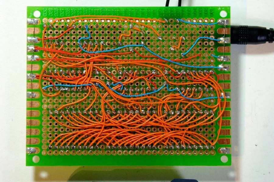 A perfboard with wires connecting electronic components.