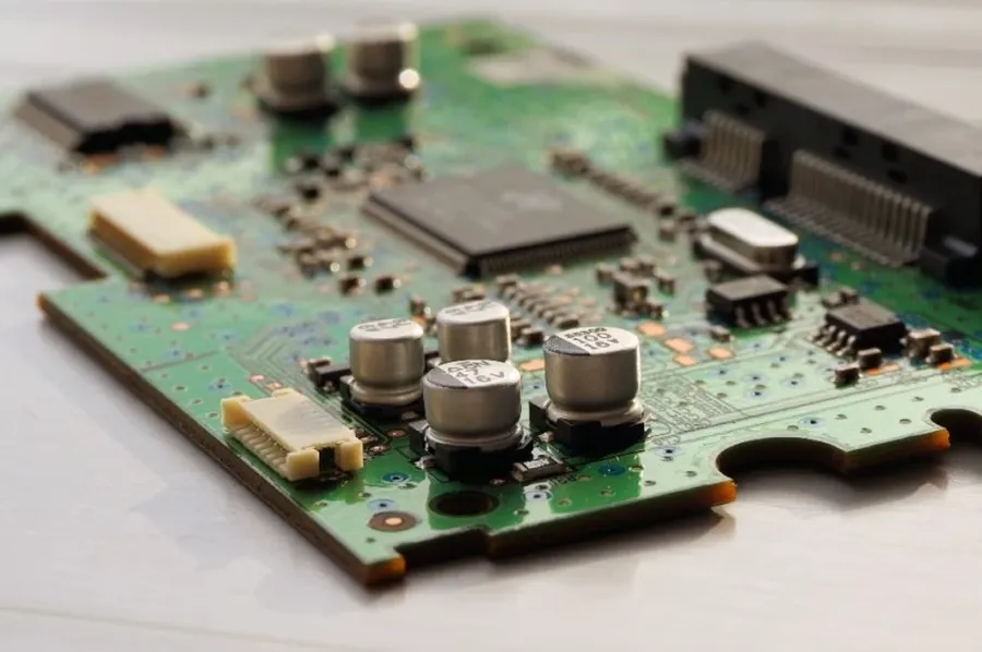 Hands selecting various electronic components including resistors.