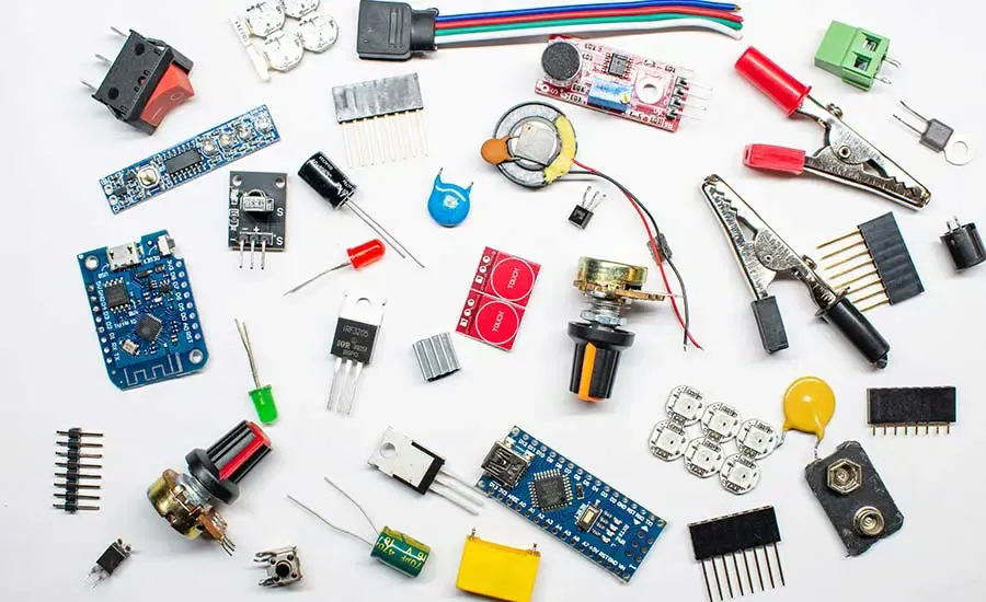 Various electronic components such as resistors, capacitors, and integrated circuits laid out on a surface.