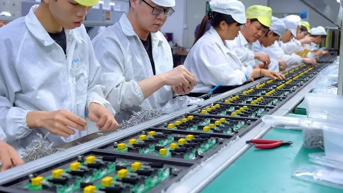 A production line view of PCBs being assembled.