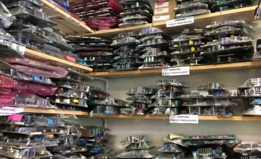 A shelf in an electronics store stocked with various electronic components.