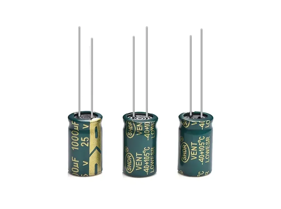 A detailed view of the leads of a radial capacitor.