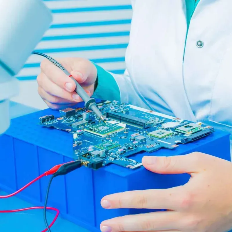 An engineer performing tests on a PCB board with equipment