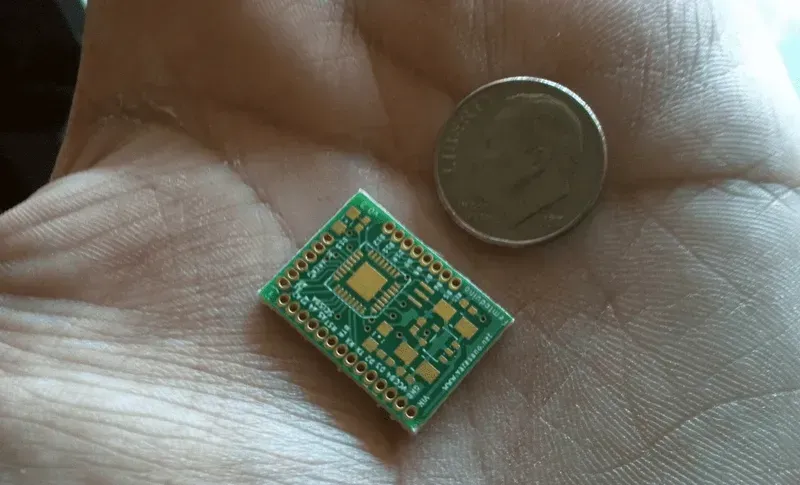 A highly miniaturized PCB board, emphasizing its small size and complex circuitry.
