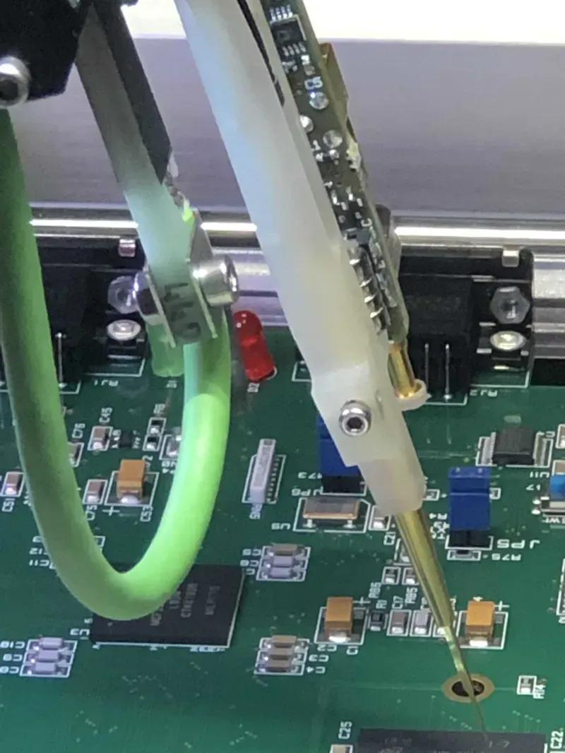 A technician performing tests on a pet locator PCB