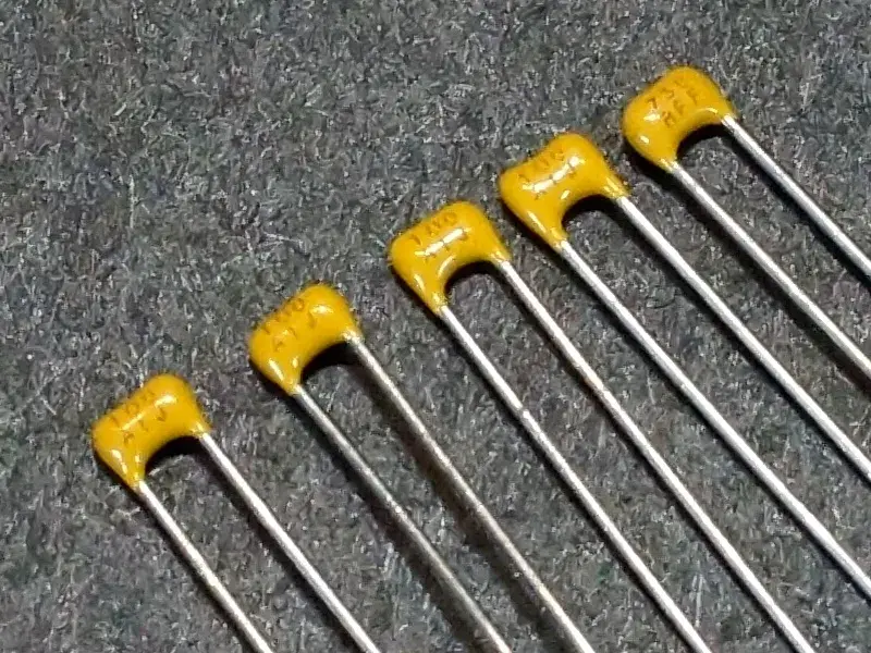 A close-up view of a small ceramic capacitor.