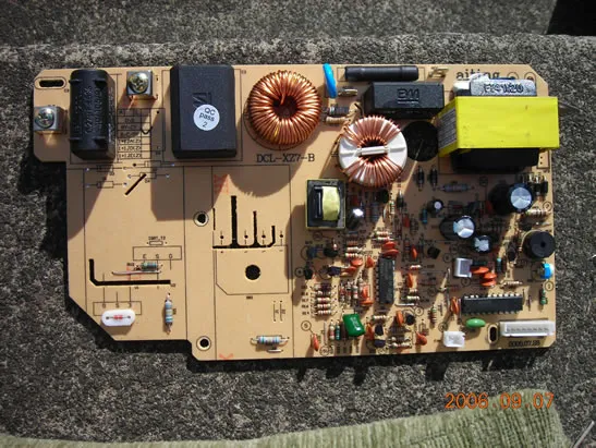 A damaged induction cooker circuit board with visible issues.