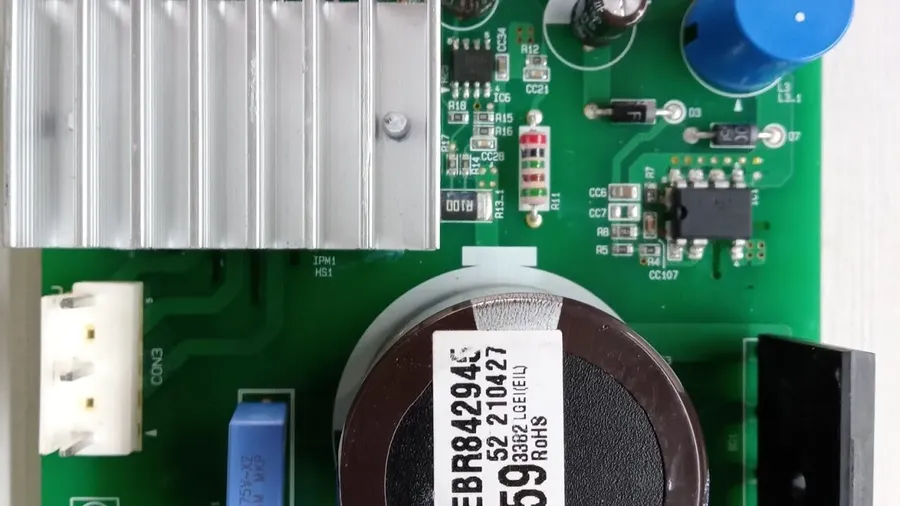 A technician repairing an LG inverter PCB board.