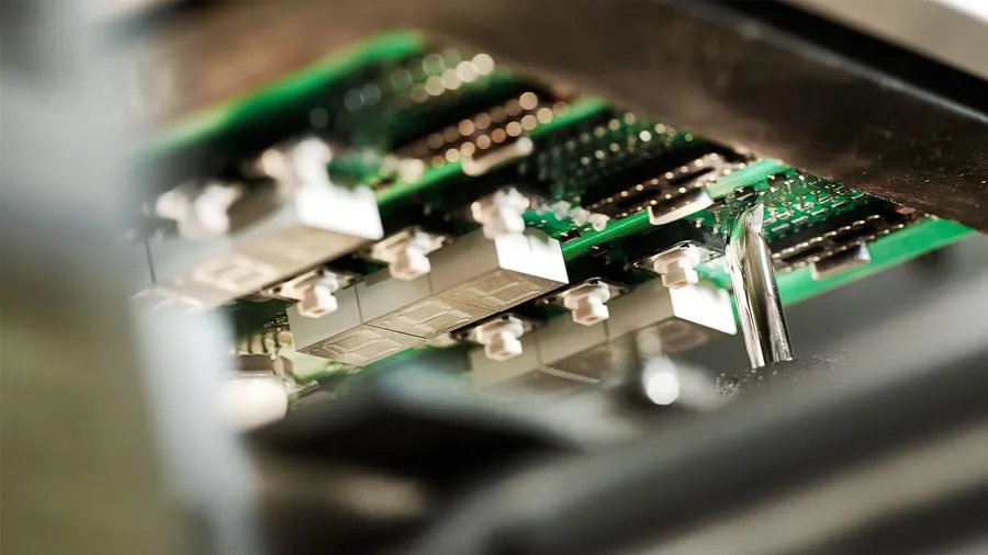 A large quantity of assembled PCBs being produced.