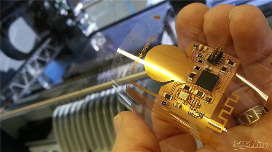 A manufacturing facility where flexible circuit boards are being produced, showing machinery and people at work.
