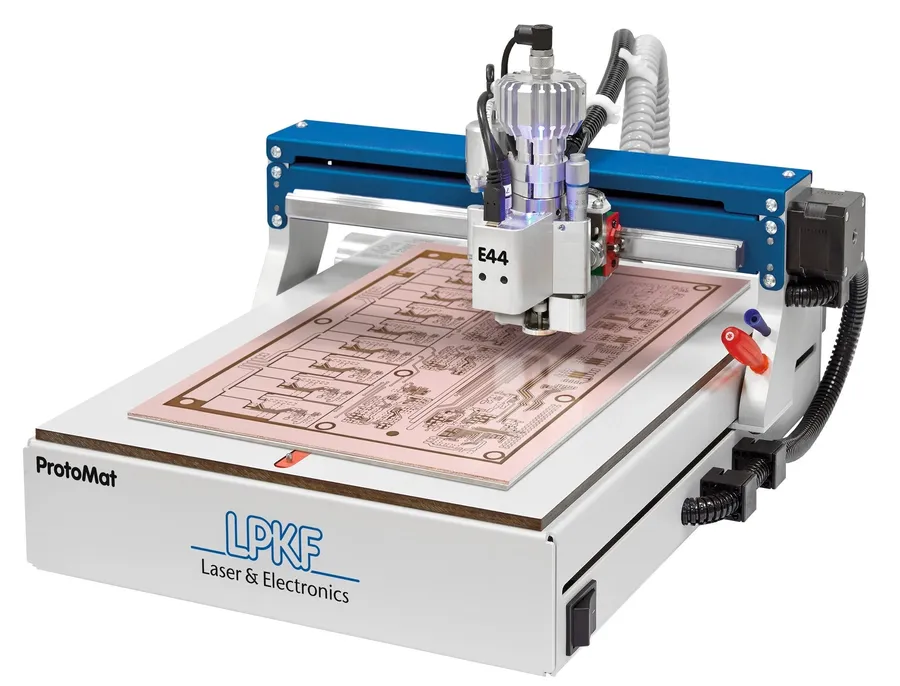 Different PCB prototyping machines on a workbench.