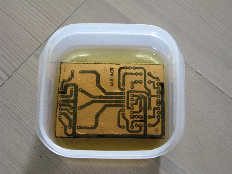 A person working on a DIY PCB project.