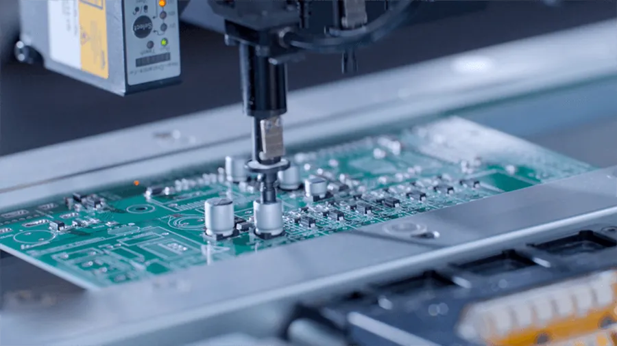 A close-up of surface mount components being placed on a PCB.