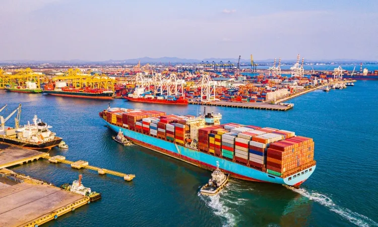 Shipping containers at a port or dock, representing global logistics.