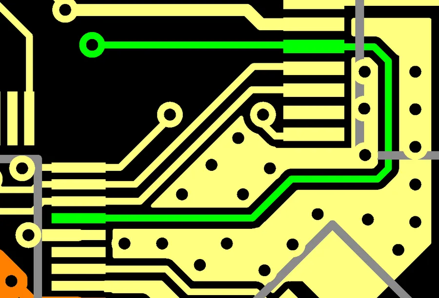 Close-up of a PCB showing copper traces and vias.