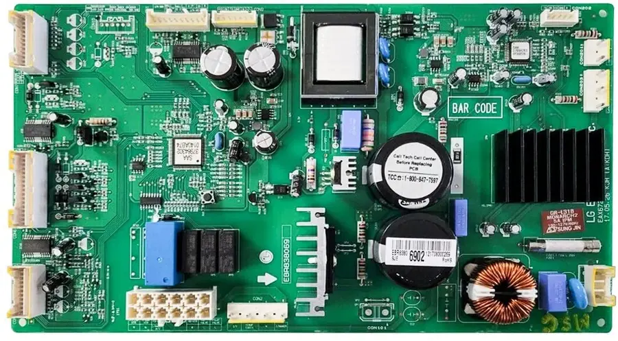 Hands installing a PCB board into a refrigerator.
