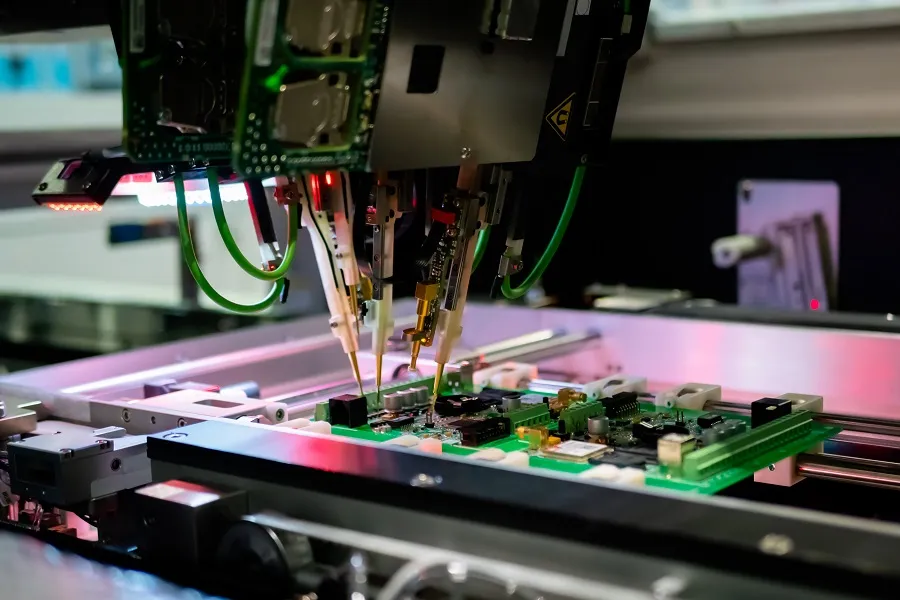 A PCB undergoing inspection with specialized testing equipment.