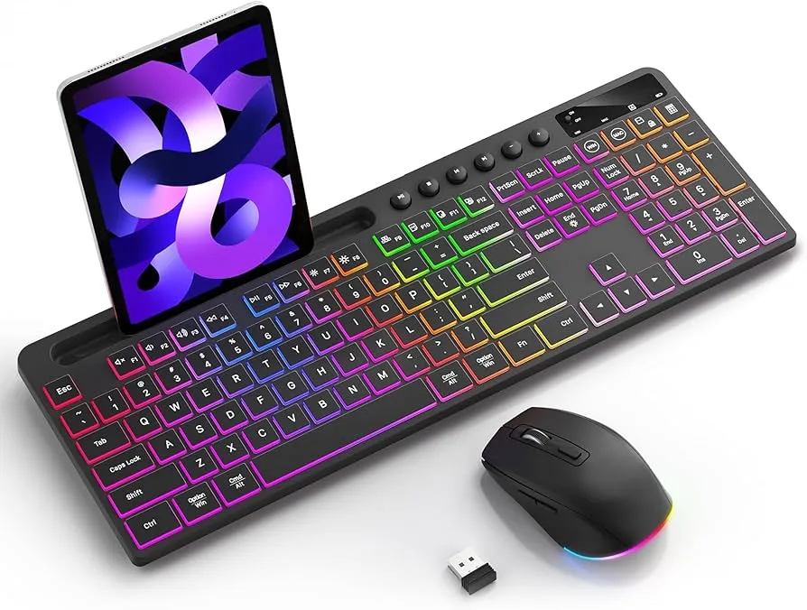 A laptop, a tablet, a computer mouse, and a keyboard on a desk.