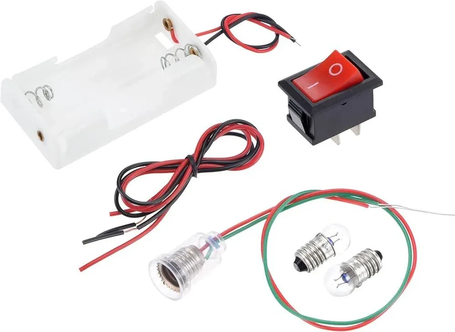 Close-up of a battery, a piece of wire, a switch and a light bulb, essential parts for a simple circuit.