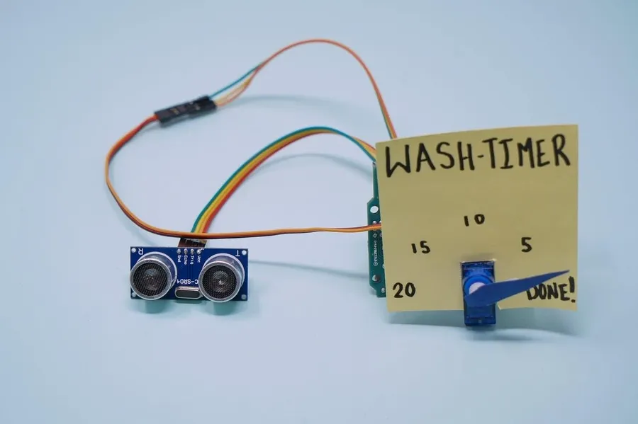 A student experimenting with a simple circuit, using a battery, wires, an LED and a resistor.