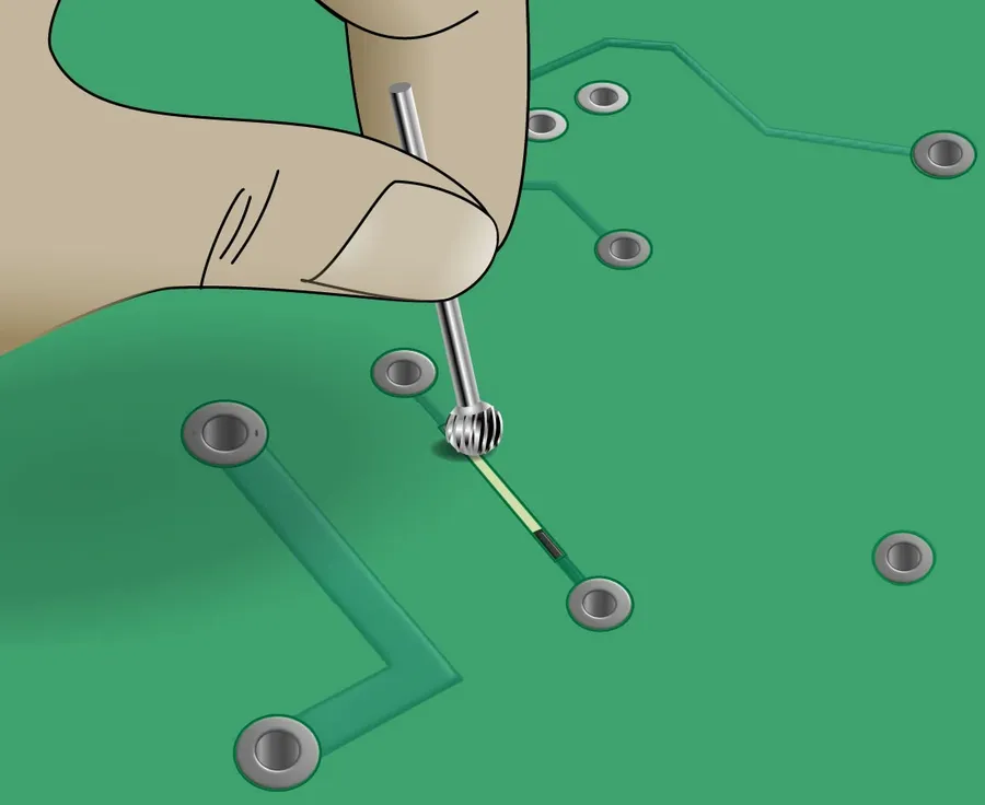 A close-up of a PCB trace being repaired.