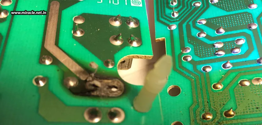 A damaged PCB with visible burn marks.