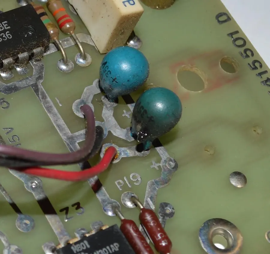 A close-up of a damaged or failed tantalum capacitor.