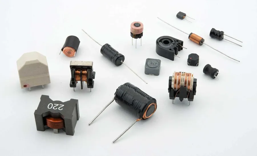 Various inductors with different shapes and sizes mounted on a circuit board.