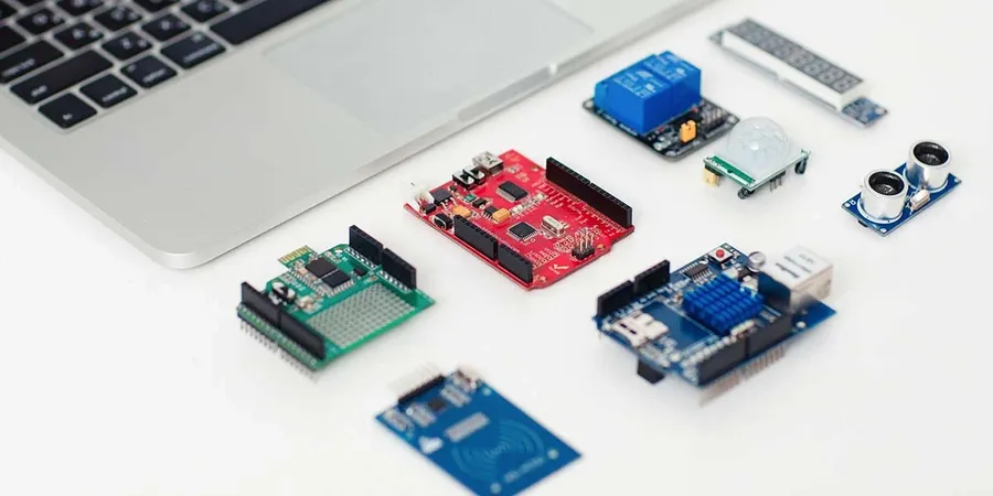 A group of people working on electronics projects together in a workshop.