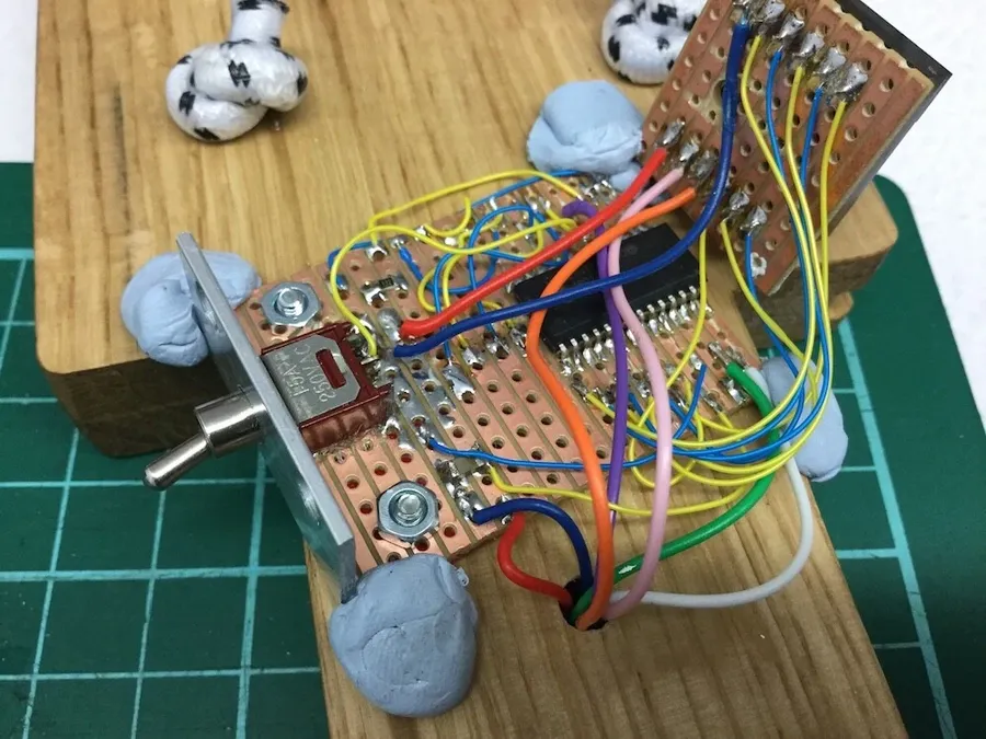 A perfboard next to a stripboard.