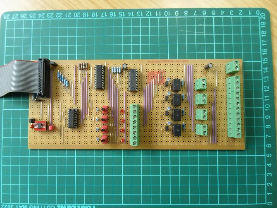 A planned layout of a circuit on stripboard, with components and cut tracks.