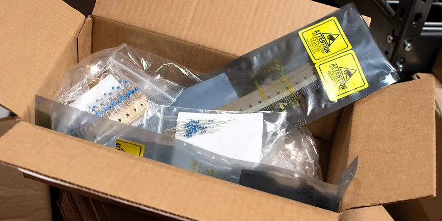 A package being prepared for shipping with labels showing origin and destination