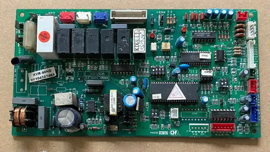 A different view of an air conditioner main PCB, highlighting its various parts.