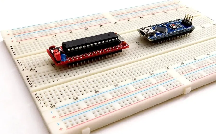 A side-by-side view of a Zero PCB board and a breadboard.