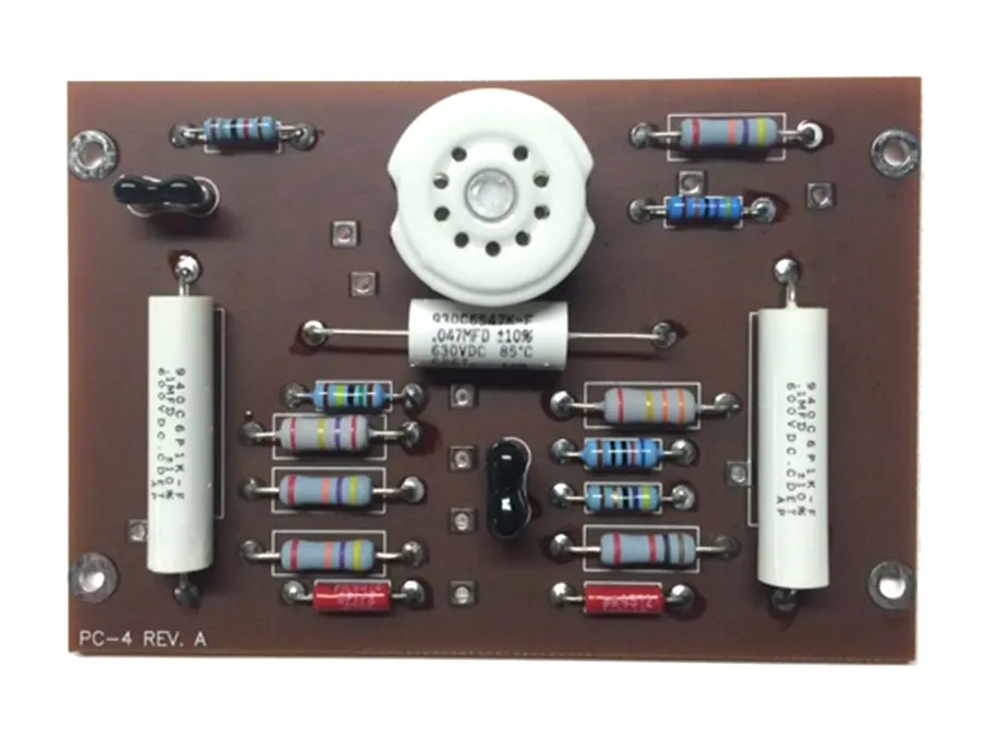A close-up of the components like capacitors and resistors on an amplifier circuit board.