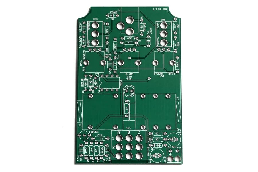 A person soldering components onto a pedal PCB.
