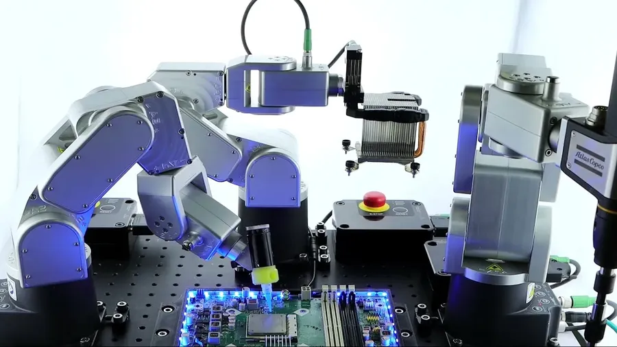 Robotic arms working on an automated electronics assembly line.