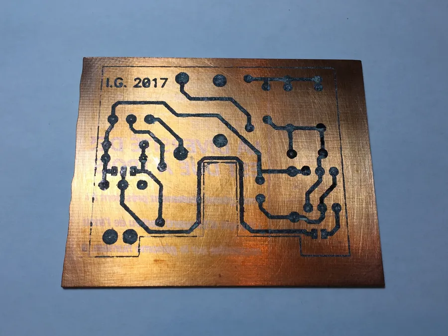 A PCB being etched in a chemical solution.