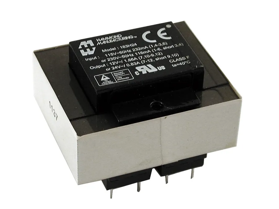 A close-up view of a label on a PCB transformer showing ratings and safety information.