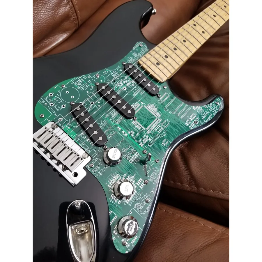 A guitar circuit board with treble bleed components, including a 1uF capacitor.