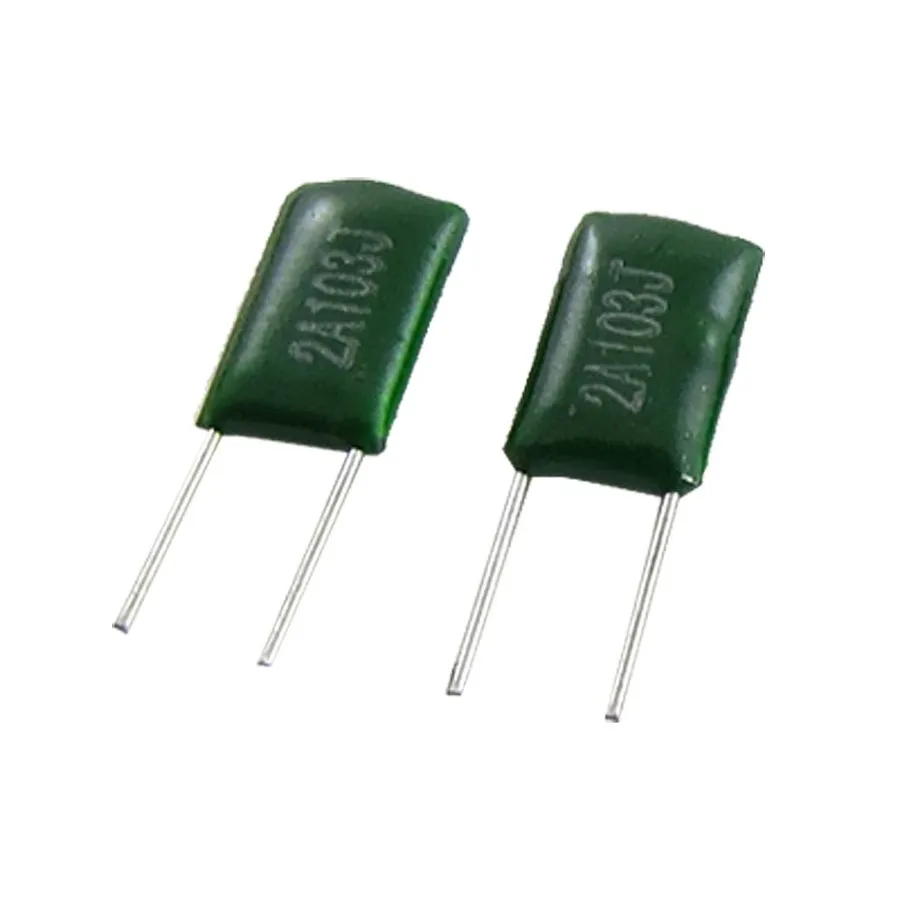A 0.01uF capacitor with a ruler or scale for size comparison.