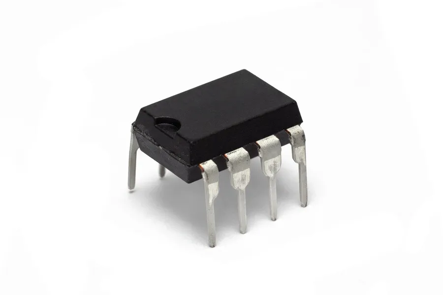 A close-up view of a 555 timer IC on a breadboard with connecting wires.