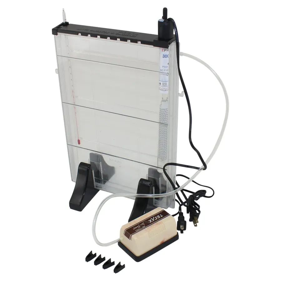 A DIY PCB etching kit and components laid out on a table.