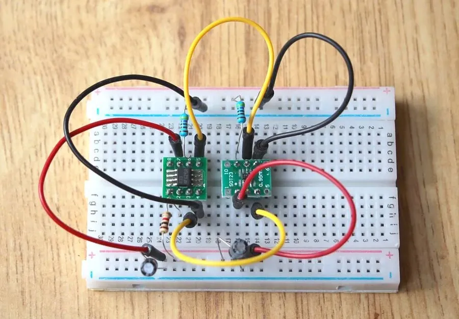 Electronic components being soldered onto a solderable breadboard.